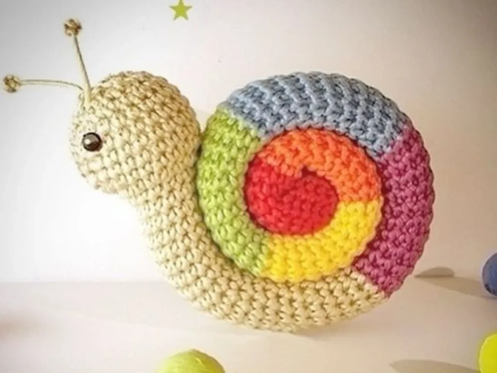 Crochet snail amigurumi with a spiral shell