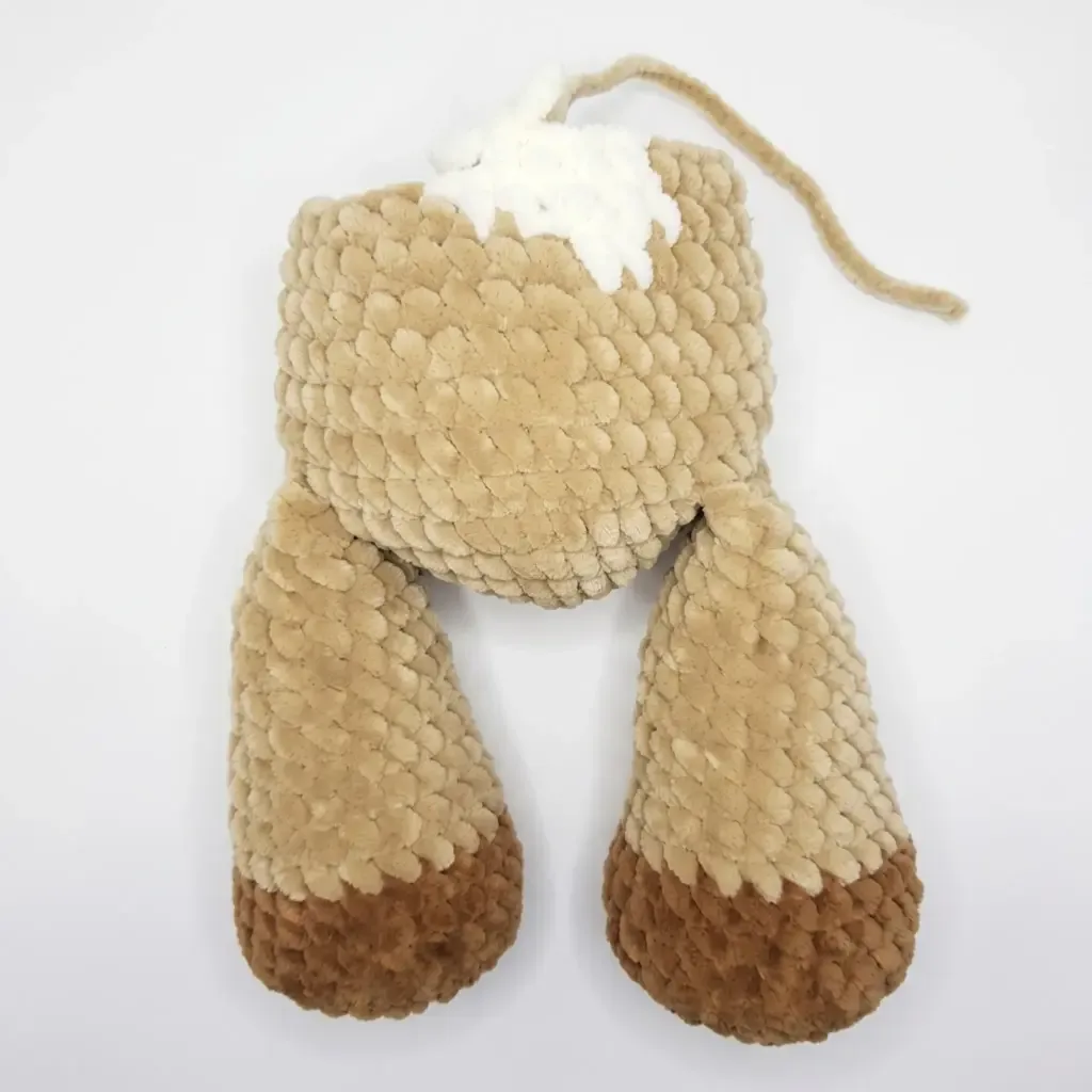 A plush bull calf amigurumi in chenille yarn