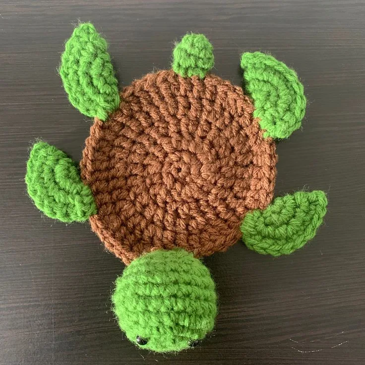 A turtle coaster crochet pattern with legs and head