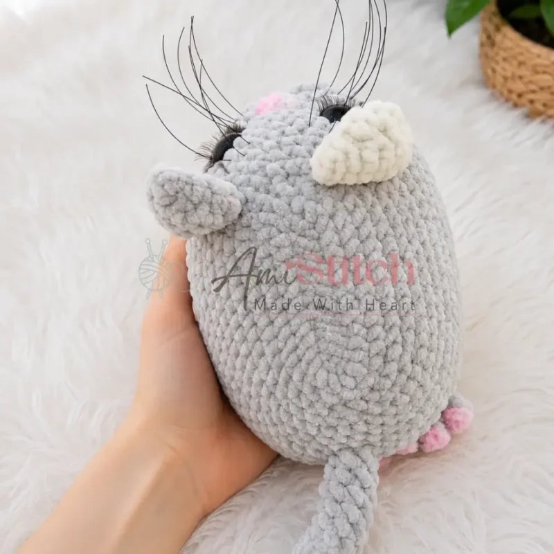 A plush amigurumi cat with tacked facial features — photo 3
